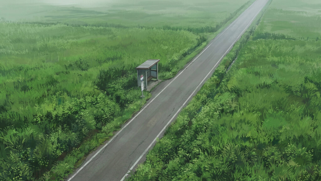 夏草が生い茂る田舎のバス停と一本道